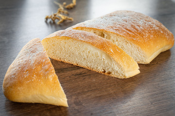 Fresh bakery, sliced bread on a wooden backround
