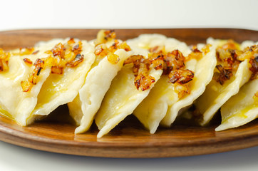 Close up of dumplings sprinkled with fried onion, traditional Polish, Russian and Ukrainian cuisine