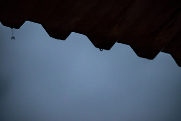 Rome, April 2020. A raindrop falls from the roof, slowly forms and then falls down.