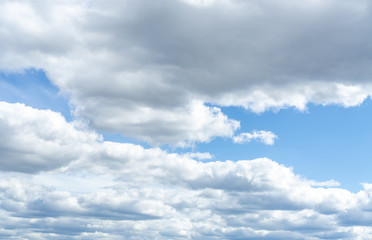 Floaty white, grey clouds  running on the sky. 
