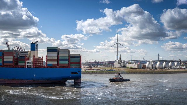 End of a container ship on the hook of a tug