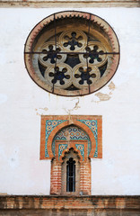Mudejar style window with tiles -alicatados- and rose window of the church of Omnium Sanctorum in Seville, Spain