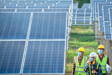 A team of engineers and three Asian architects walked to visit the solar panel. Engineering team...