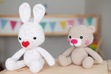 Crochet amigurumi toy for baby. white crochet bunny and teddy bear.