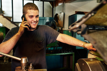 Professional machinist : man operating lathe grinding machine