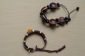 Handmade bracelets for women on a beige textured background.