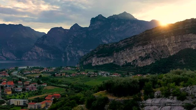 Panorama of Torbole a small town on Lake Garda, Italy. Europa, beautiful Lake Garda surrounded by mountains in the summer time at sunset