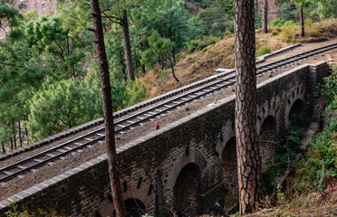 high angle shot of railway bridge with trees in the background.