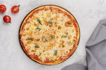 Classic italian pizza margarita. Served on a wooden board. Food delivery.