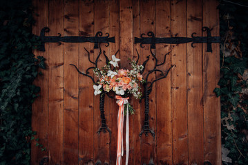 Beautiful stylish wedding bouquet close-up on the background of a wooden gate. Wedding Floristics