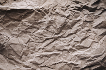 Old crumpled vintage background from paper, which is used as a wrapper. The texture of cardboard made from recycled materials.