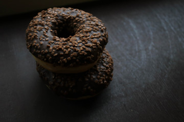 Chocolate donuts on a brown background