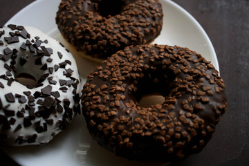 Chocolate donuts on a white plate