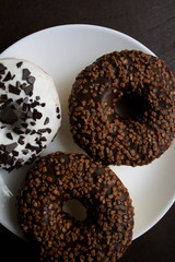 Chocolate donuts on a white plate