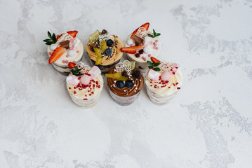 Set of beautiful delicious trifl close - up on the background. Dessert and sweets