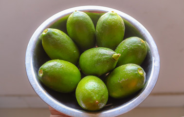 green juicy lemons in a bowl