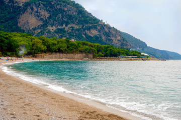 sandy beach of the mediterranean sea with mountain views and turquoise water in Turkey