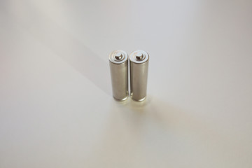 Two aa gray batteries on a white background