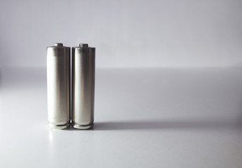 Two aa gray batteries on a white background