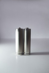 Two aa gray batteries on a white background