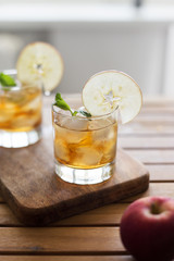 Apple juice in glasses with ice and mint