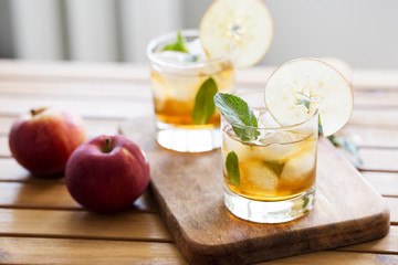 Apple juice with ice, mint and apple slice as garnish