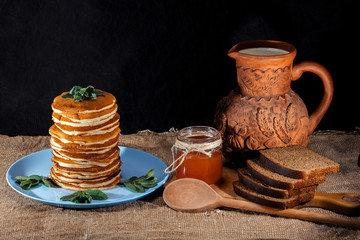 Appetizing domestic pancakes with maple syrup at rustic  style