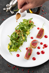 beautiful food: steak tuna in sesame, lime and fresh salad close-up on a plate on the table