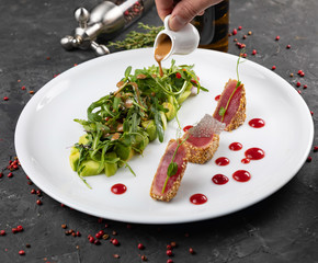 beautiful food: steak tuna in sesame, lime and fresh salad close-up on a plate on the table