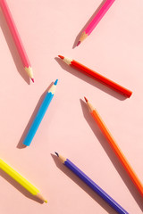 Pattern of colorful pencils. Red and blue pencils on pink background. Back to school, education and learning concept. Minimalist isometric concept.