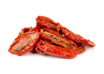 Dried tomatoes on a white background. Slices of dried tomatoes in oil close up.