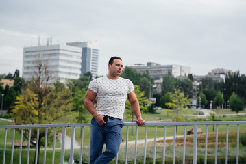 Sports guy stands and talks on the phone. Lifestyle