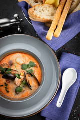 TOM YAM is a traditional Thai soup. On a black background
