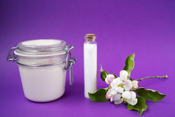 Hand made body cream or lotion and salt on the brown background. Apple blossoms. Natural cosmetics. Small business. Copy space.