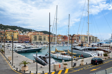 View of old port Lympia on Mediterranean sea with luxury yachts and boats parking area at port near colorful buildings. Nice, French Riviera, France, 