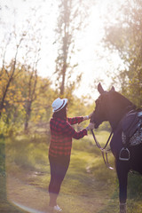 beautiful girl walks with a horse