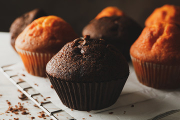 Composition with tasty muffins on white wooden background