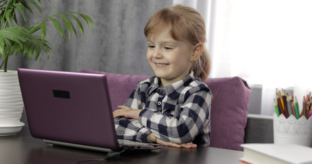 Girl studying online homework using digital laptop computer. Distance education