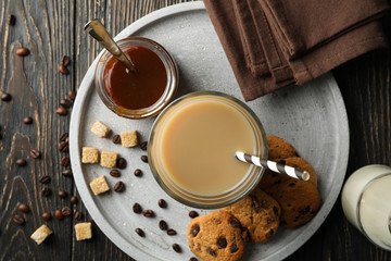 Composition with ice coffee and cookies on wooden background