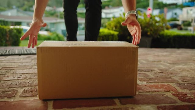 Contactless delivery of a parcel, courier delivering package to the doorstep