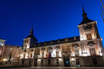 Fototapeta premium Casa de la Villa, in the center of Madrid, Plaza de la Villa. Photo at sunset, dusk with the building illuminated.