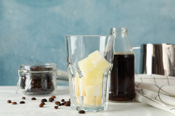 Composition with ice coffee on white wooden background