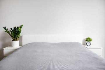 minimalistic modern bedroom interior - bed and copy space over white wall