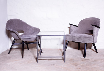 Gray anthracite color armchair. Modern designer armchair in the room background.