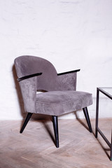 Gray anthracite color armchair. Modern designer armchair in the room background.