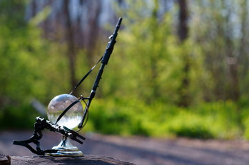 A small glass globe with a toy weapon.