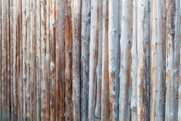 Wooden fence made of tree trunks. Background image.