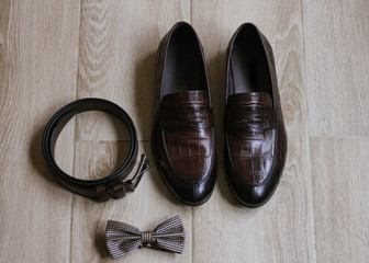 Wedding details. Groom accessories. Shoes, belt, and bowtie