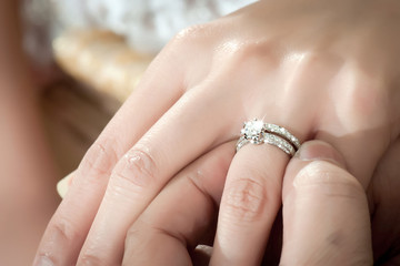 Groom wears the bride a wedding ring
