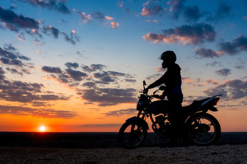 Naklejka na ściany i meble Motorcyclist enjoy at sunset sky 
